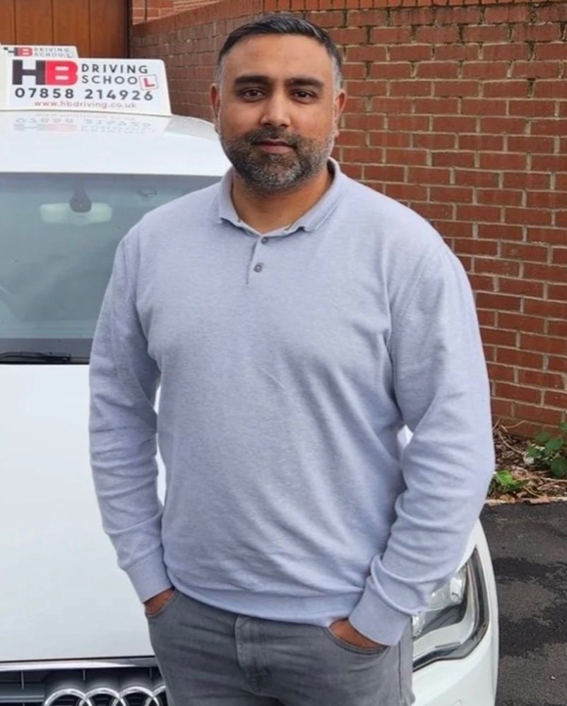 Khurim, HB Driving School automatic driving instructor, with a branded lesson car in Manchester