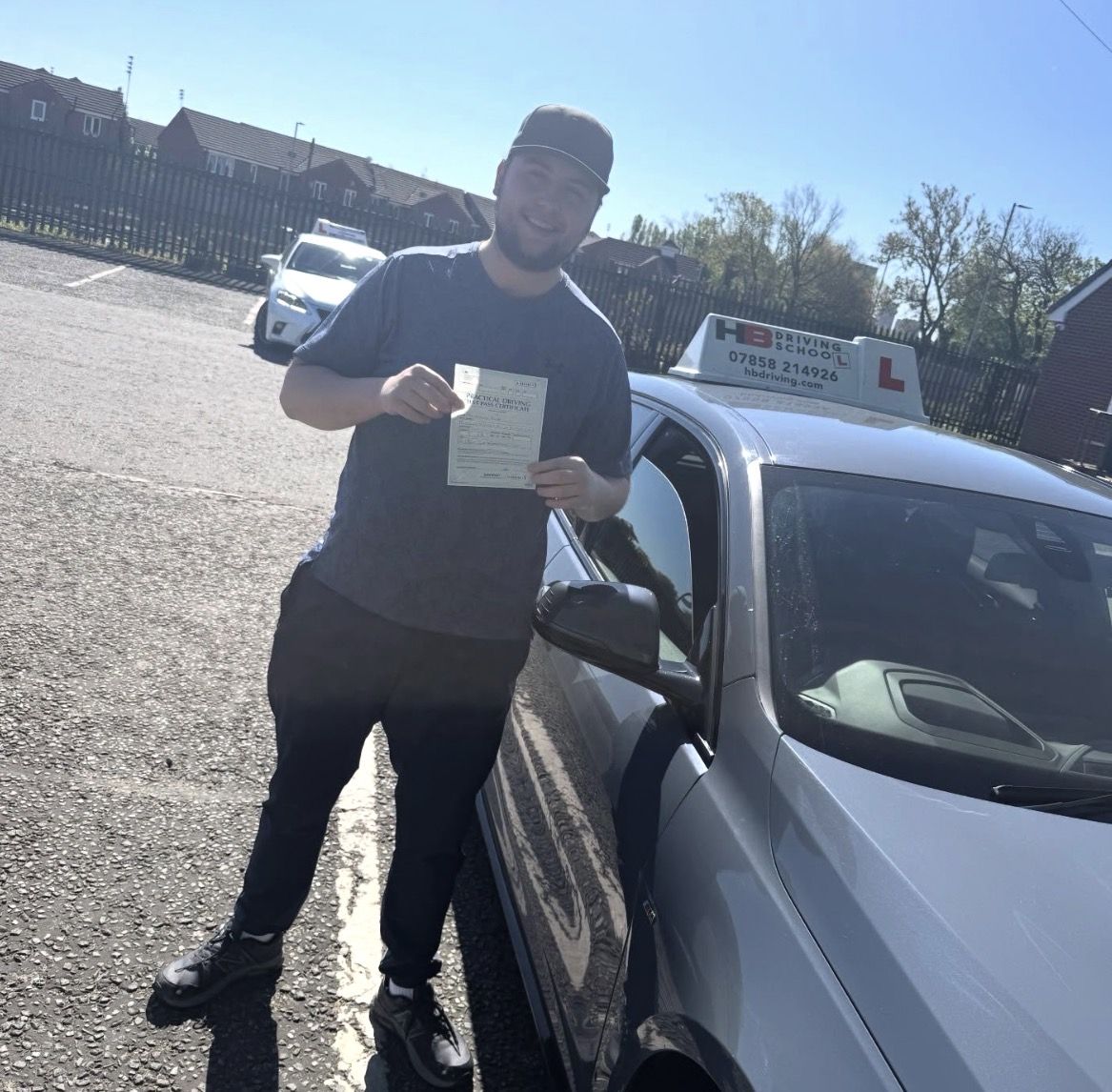 HB Driving School learner celebrating with his practical driving test pass certificate