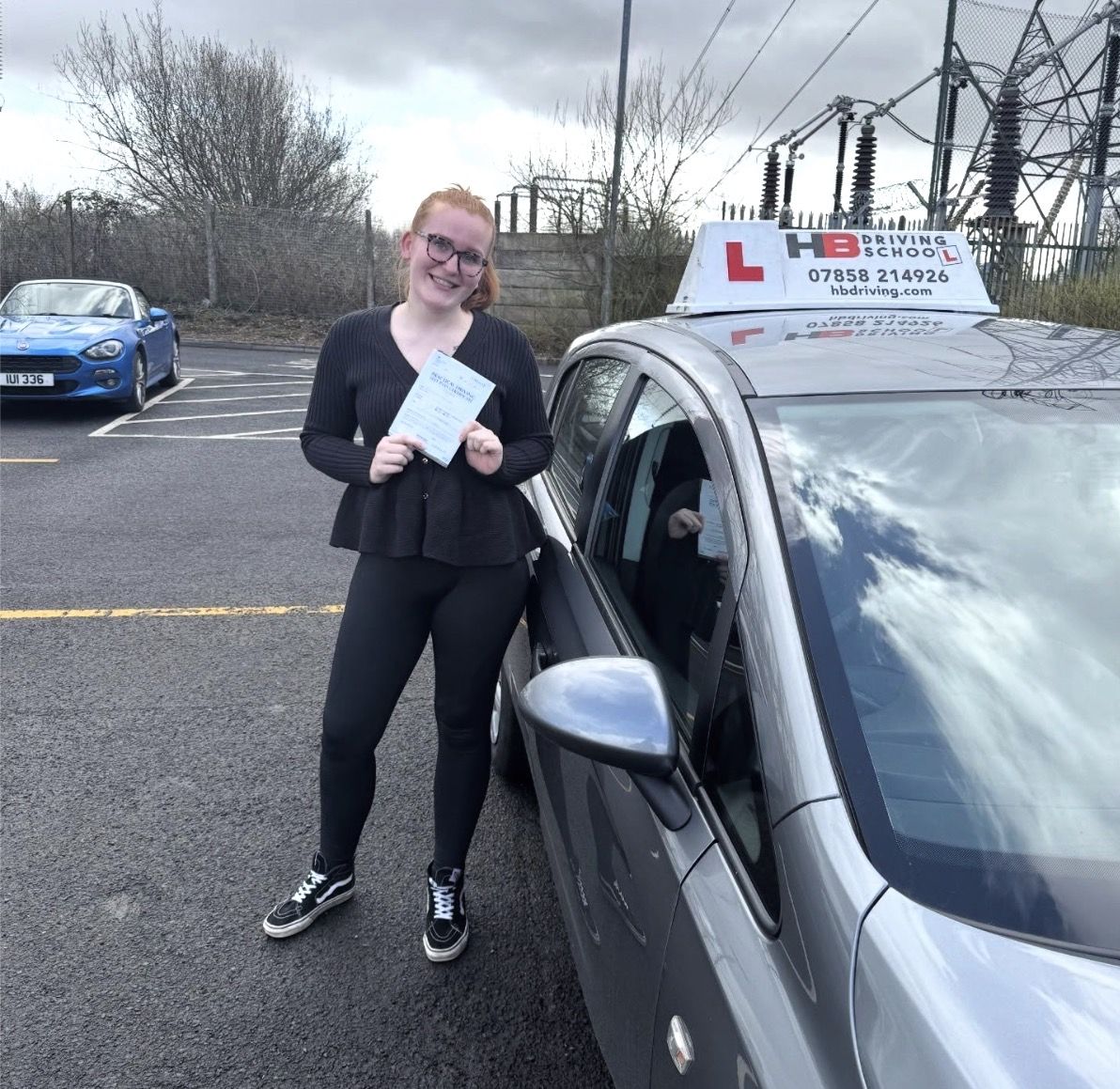 HB Driving School learner celebrating with her practical driving test pass certificate